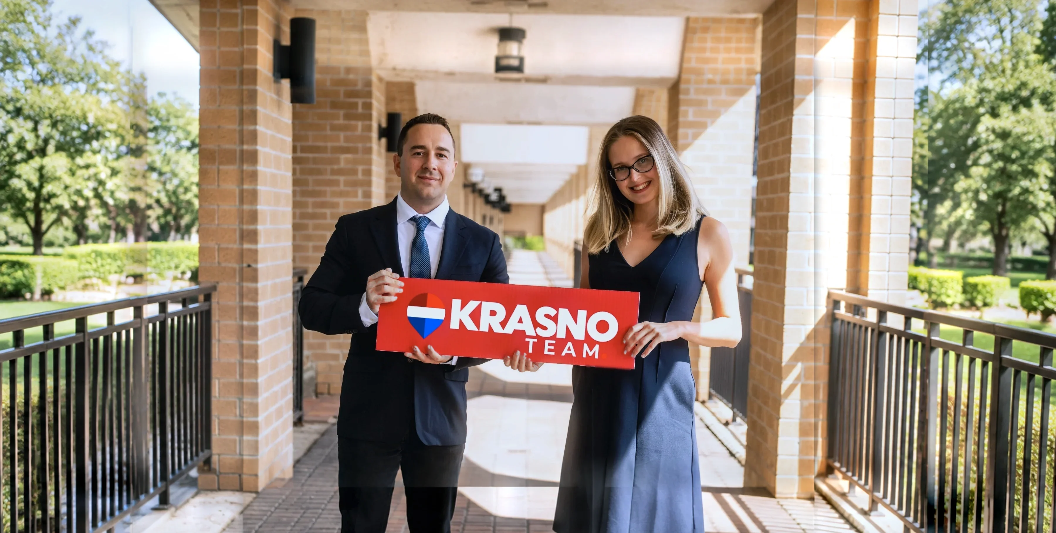 Anthony Krasno and Ana Yakovleva of the Krasno Team holding a Krasno Team sign